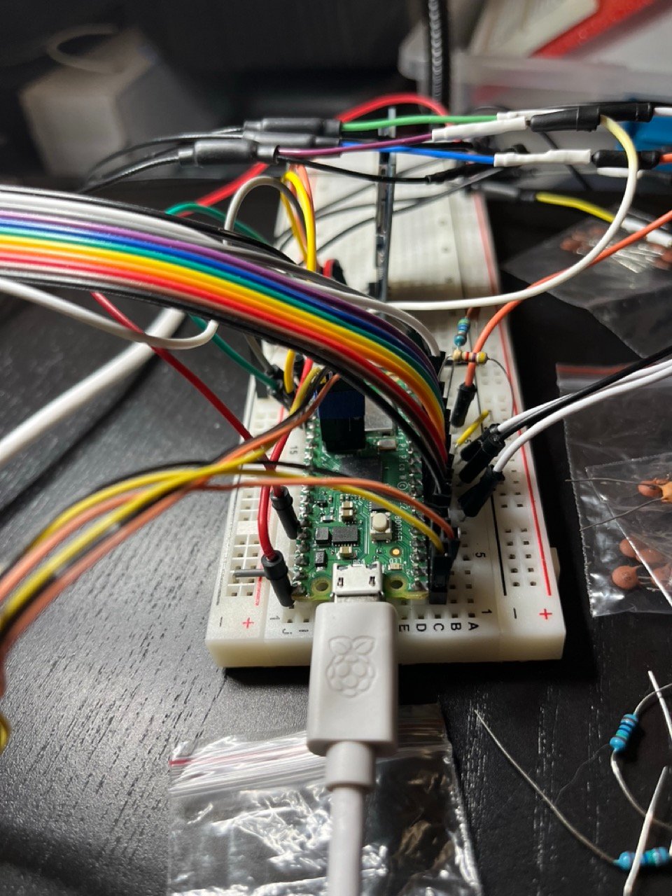 The Pico W on the breadboard, ribbon cable from the card's header.