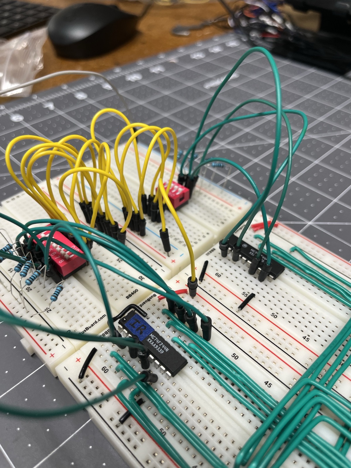 Two DIP switches standing in for the opcode and the timer state, jumpered into the ROM address pins. Outputs were read with a multimeter, one pin at a time.