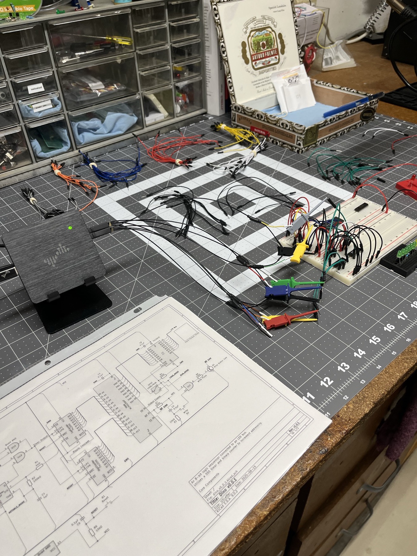Where it started. Dino v0.0.1, schematic dated 2025-06-15: an 8-bit logic sequencer, a 555 timer and a binary counter stepping an EEPROM into an LED bus. One breadboard and a logic analyser.