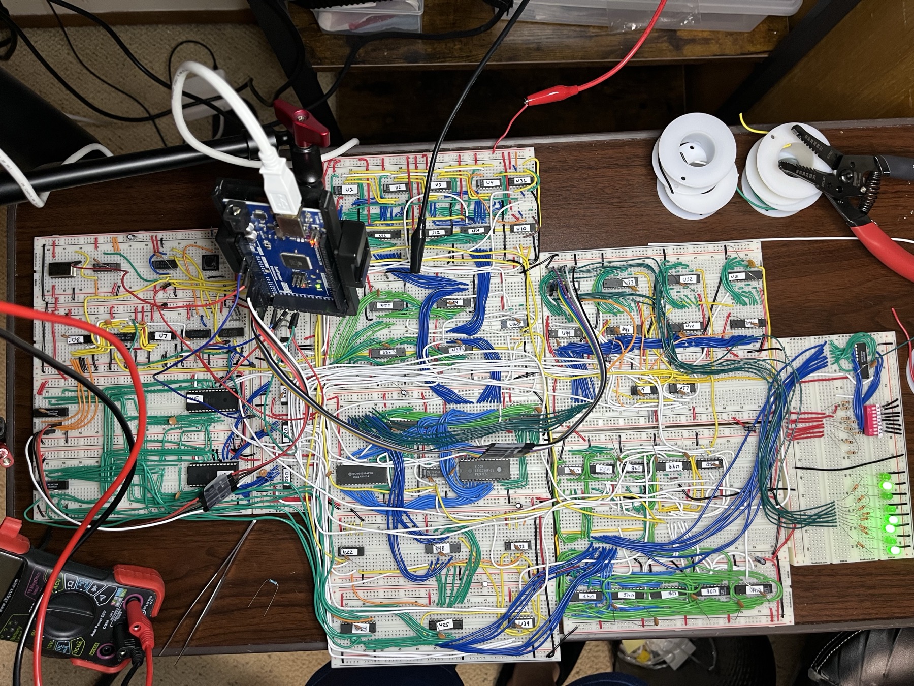 The machine, top-down, 2026-09-10. Microcode and T-state decode on the left, the program counter across the top, RAM, program ROM and the MDR board in the centre, registers and the ALU on the right, the LED and DIP switch board at the far right.
