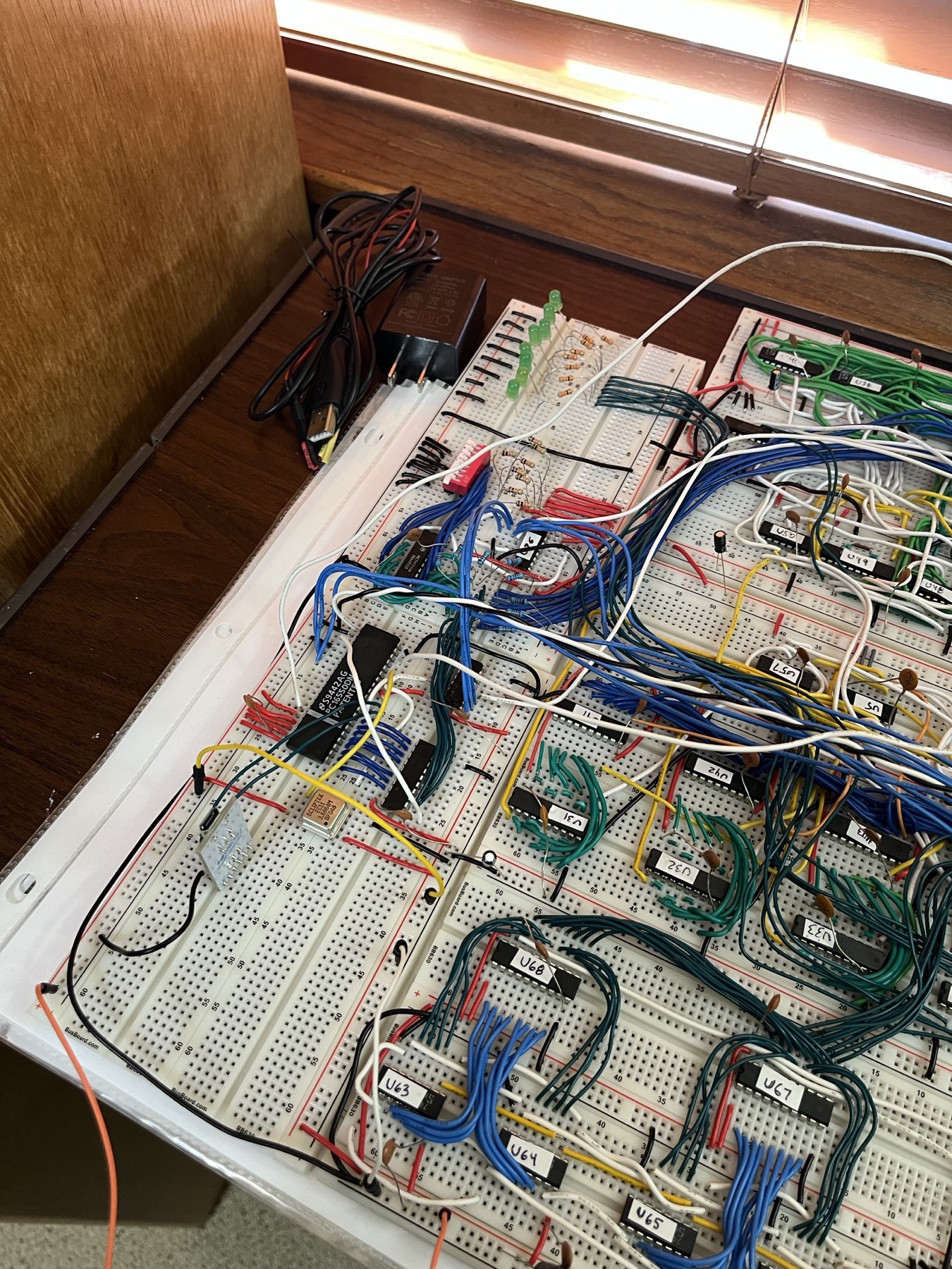 The I/O corner. The last two things to go onto the breadboard: the DIP switch as card zero at 0x4000 and the serial card, a PC16550D with its 3.6864 MHz can and the FTDI breakout, at 0x4800. Both are just memory to the CPU. The stack pointer '169s (U63-U68) sit below them.