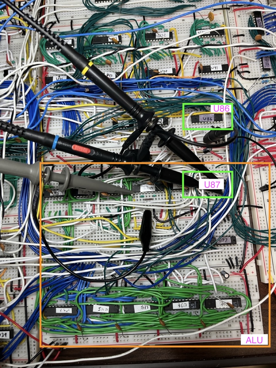 Where the two flag chips ended up. U86, the PUSHF buffer, sits in the last free row of the registers board, right above the ALU. U87, the POPF mux, took the last free spot on the ALU board's top row, next to the flags register. The interrupt logic and U85 are on a new board out of frame, top left.