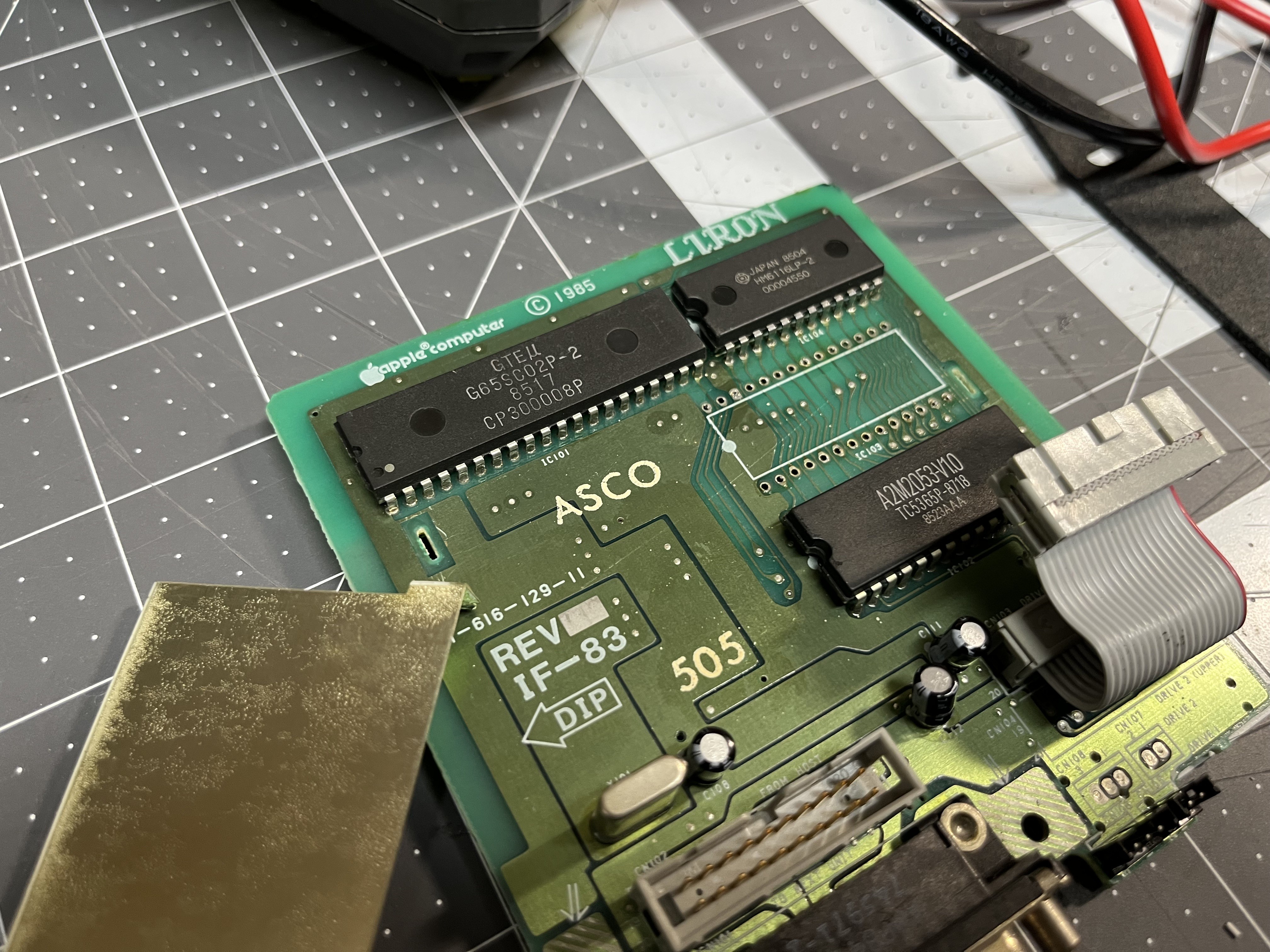 The donor: a dead IF-83 drive board with the shield off and its IWM desoldered from IC103. No socket here either.