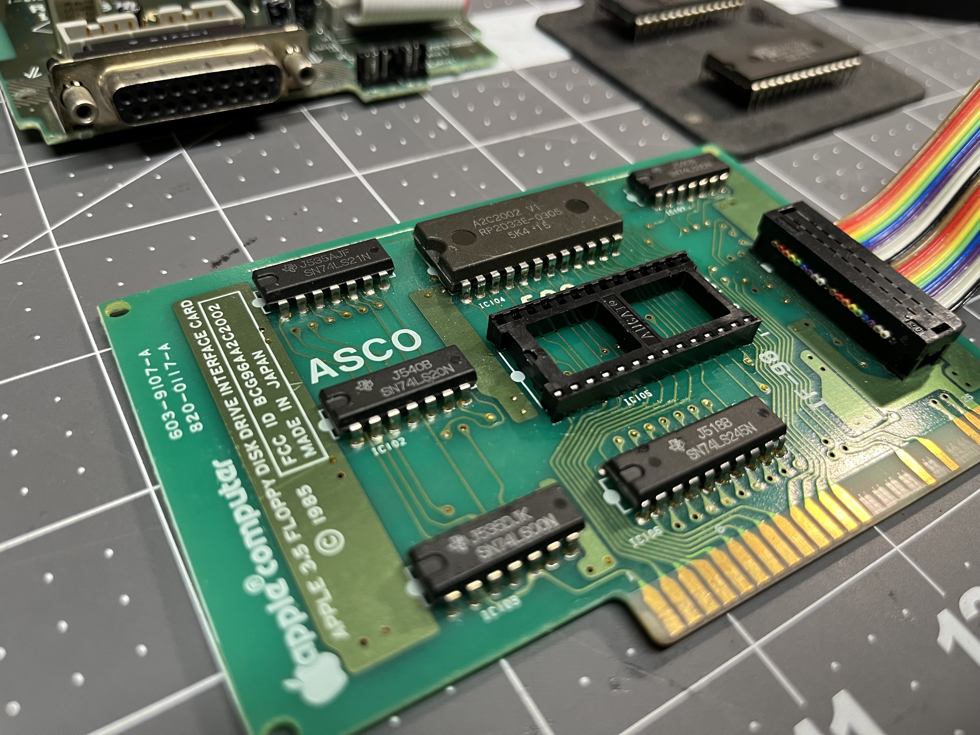 The Liron card (820-0117-A) with the dead IWM desoldered and a new socket at IC105.
