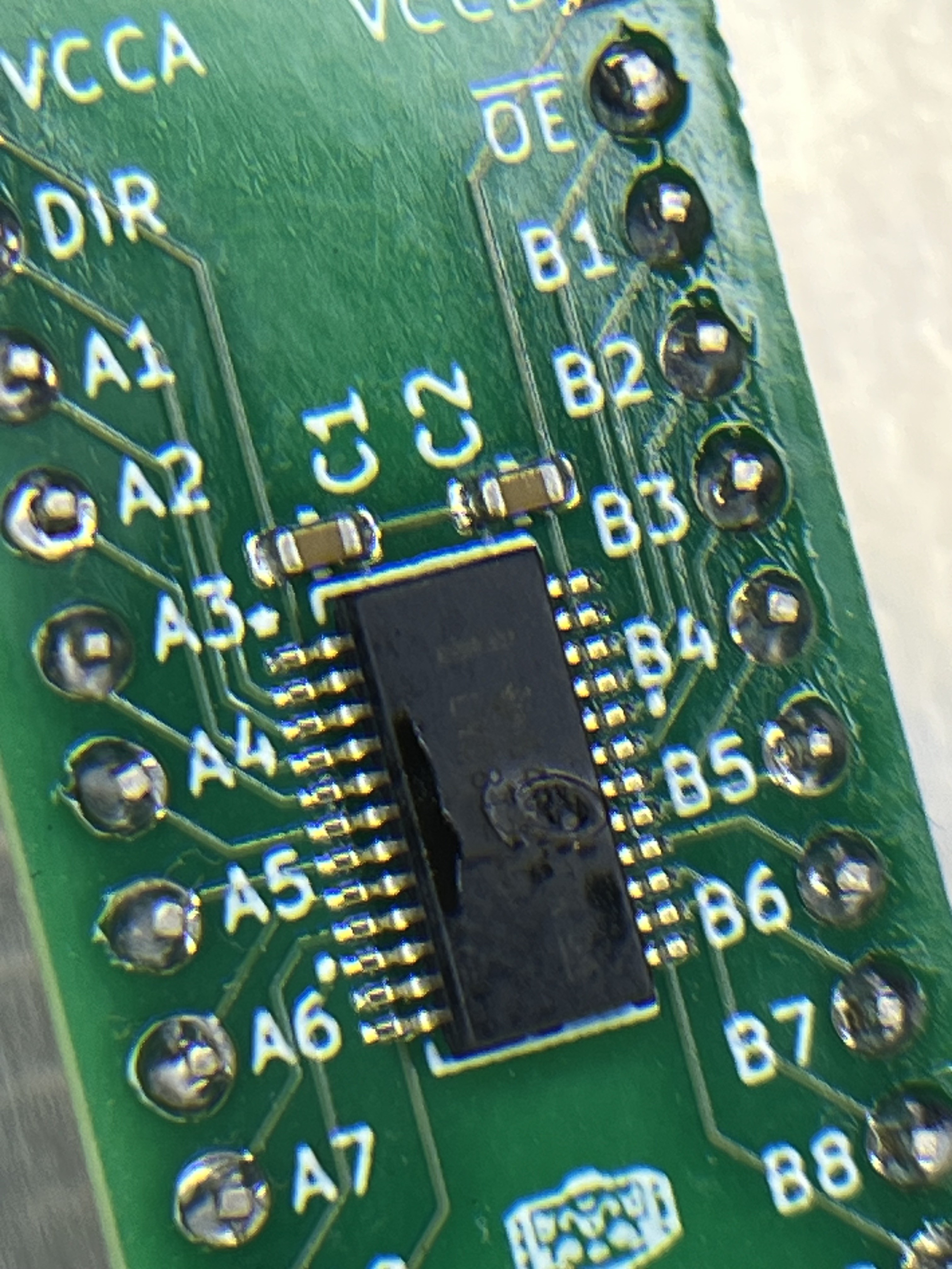 U1, the SN74LVC8T245 for the host inputs, after -12 V reached its 5 V side. The package cracked across the die.