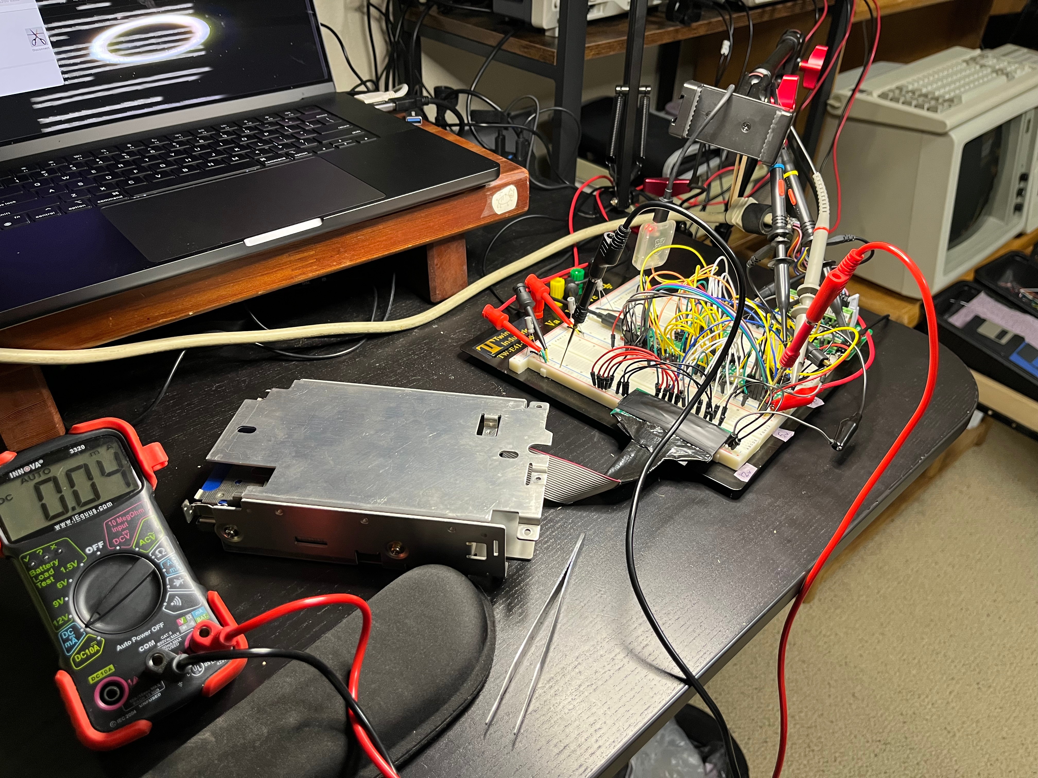 Everything wired for M7: the Pico and level shifters on the breadboard, the Sony mechanism on its ribbon, the scope probes on the host bus.