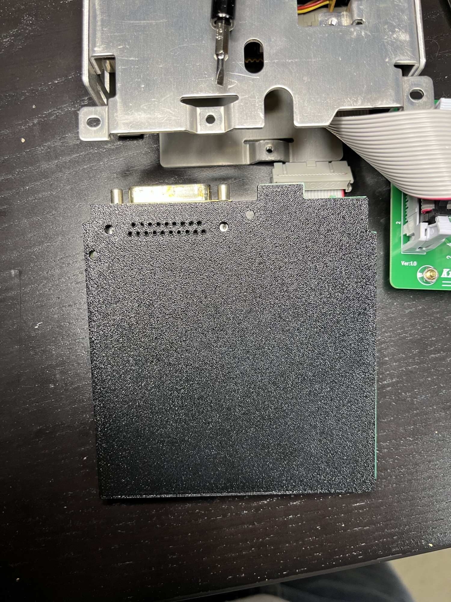 The print from the solder side, next to the chassis. The DB-19 pins and board locks come through.