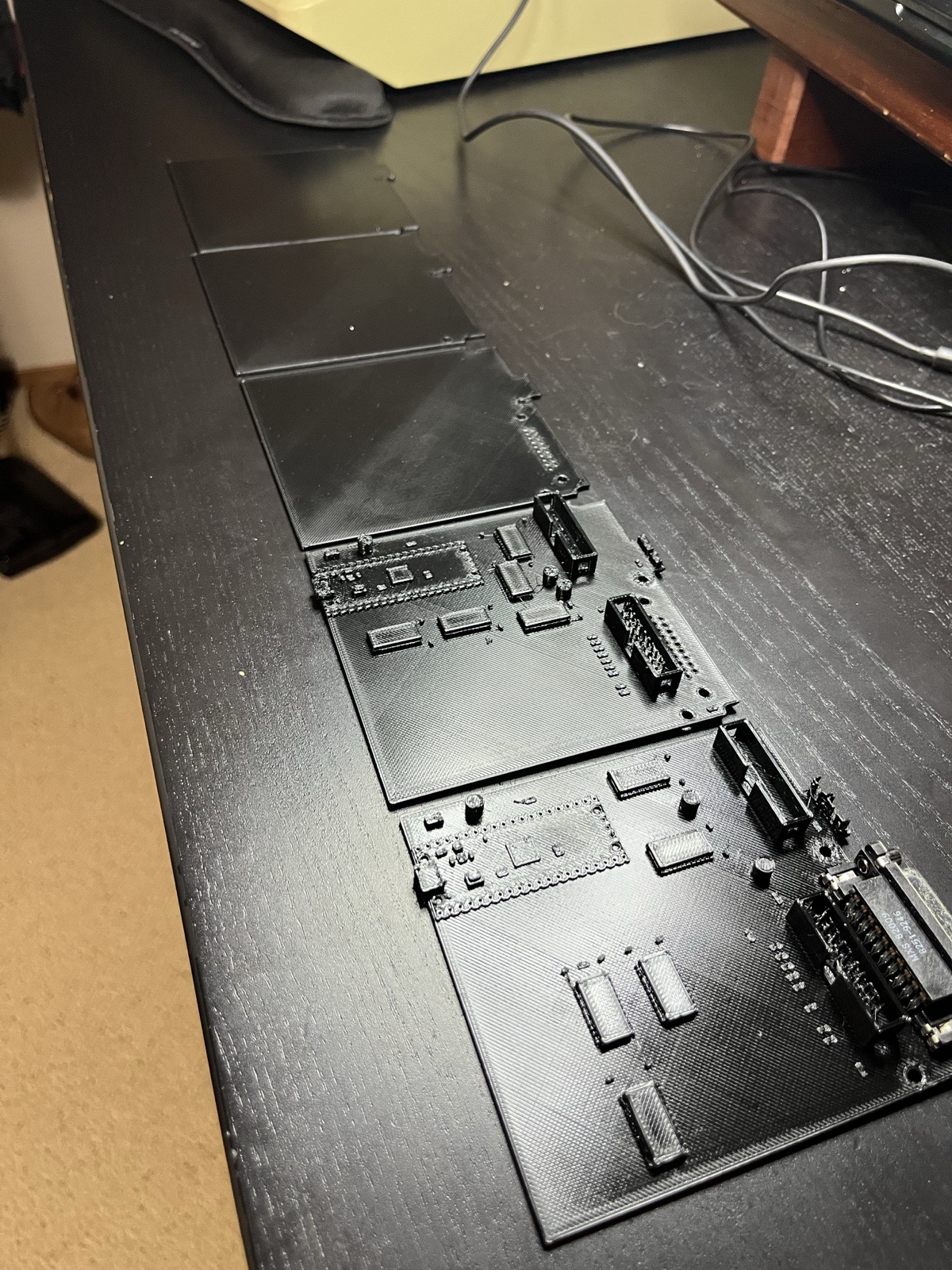 Five prints of the same board, oldest at the back: outline, outline, outline with the DB-19 holes, first layout, second layout.